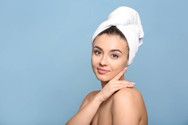Beautiful young woman with silky skin after spa treatment on color background - Photo, Image