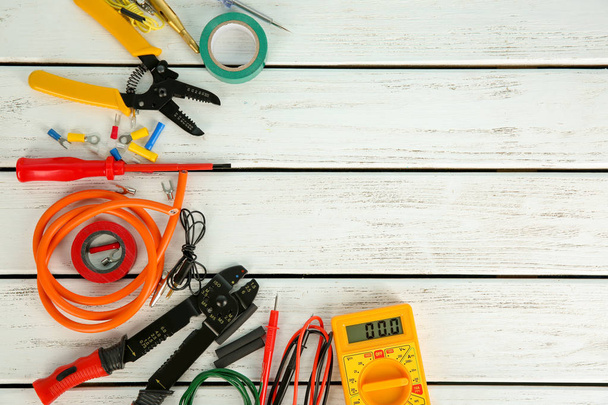 Flat lay composition with electrical tools on wooden background - Photo, Image