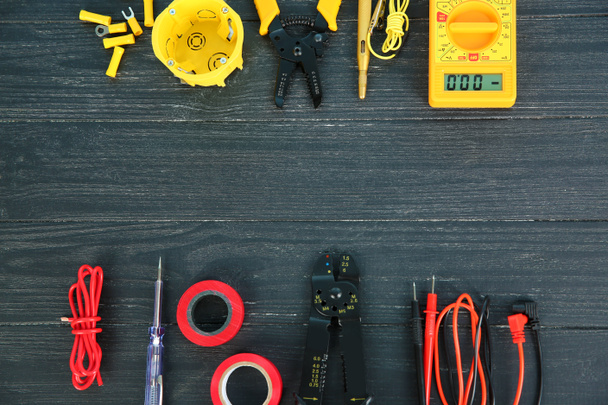 Flat lay composition with electrical tools on wooden background - Photo, Image