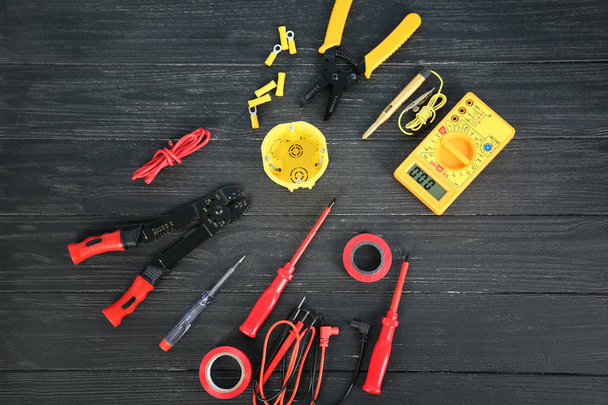 Flat lay composition with electrical tools on wooden background - Foto, imagen