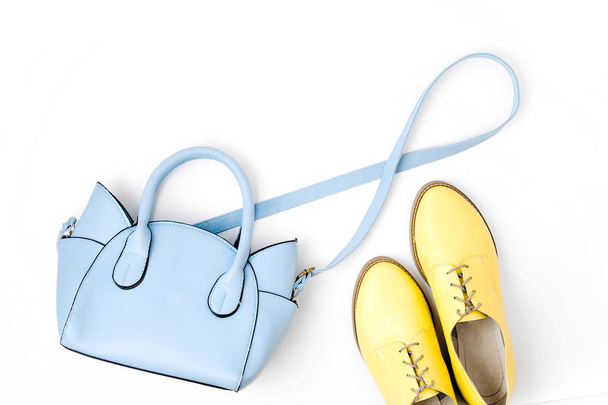 Lovely blue ladies bag and stylish yellow shoes isolated on white background - Photo, image