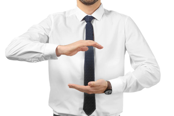 Young businessman holding something on white background - Photo, Image