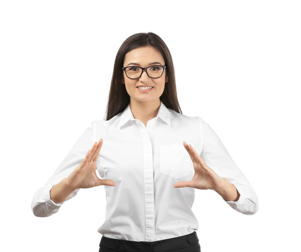 Young businesswoman holding something on white background - Фото, изображение