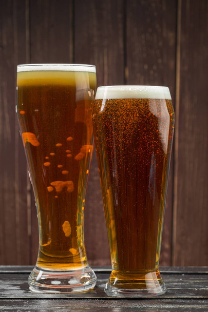 beer glasses on a wooden background - 写真・画像