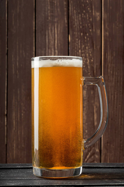 beer glass on a wooden background - 写真・画像