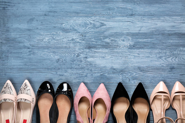Female stylish shoes on wooden background, top view - Foto, Bild