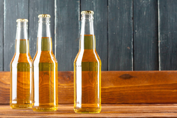 Bottles of beer on wooden table - Foto, Imagen