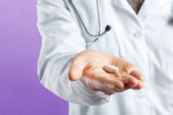 Doctor holding pill in hand - 写真・画像
