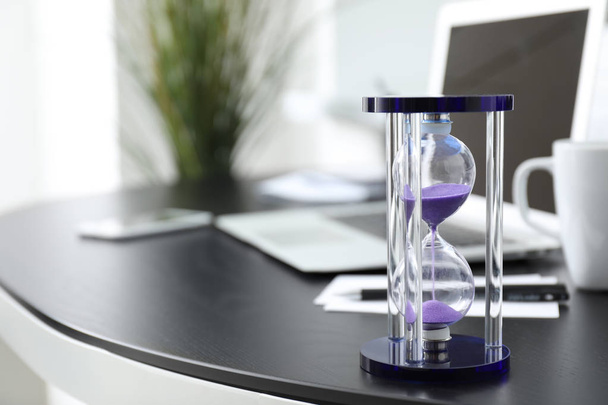 Zandloper op tafel in office. Time management concept - Foto, afbeelding