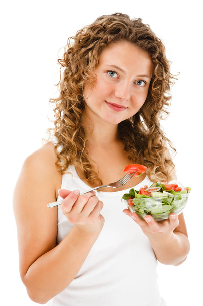 Young woman eating vegetable salad isolated on white background - Φωτογραφία, εικόνα