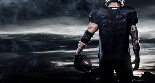 American football sportsman player over sky background. Sports banner and wallpaper with copyspace. - 写真・画像