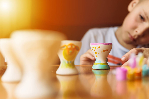 Little child draw eggs on the table with blur background and cop - Foto, Imagem