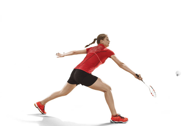 Young woman playing badminton over white background - Foto, Bild