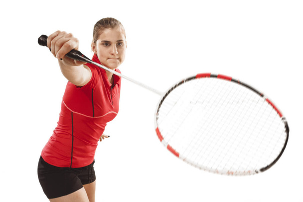 Young woman playing badminton over white background - Φωτογραφία, εικόνα