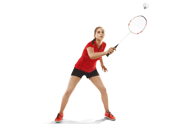 Young woman playing badminton over white background - Foto, Imagen