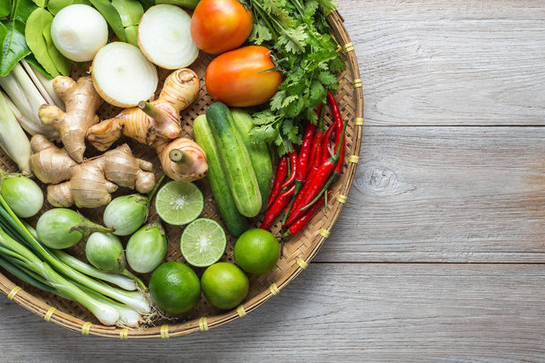 Mix of Thai vegetable in bamboo tray on wooden background. - Zdjęcie, obraz