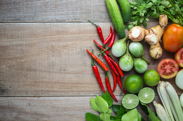 Mix of Thai vegetable in bamboo tray on wooden background. - 写真・画像