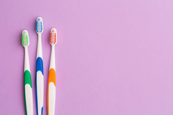 Photo of three colored toothbrushes - Φωτογραφία, εικόνα