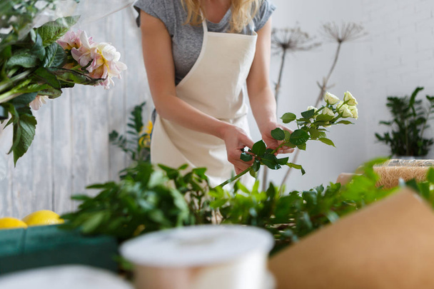 Photo of young florist girl - Foto, afbeelding