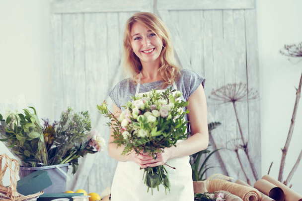 Florists woman working at greenhouse. - 写真・画像