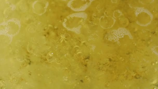 Abstract close-up on the surface of boiling water and oil - Footage, Video