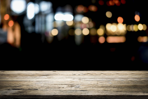 Empty wooden table platform and bokeh at night. - Photo, Image