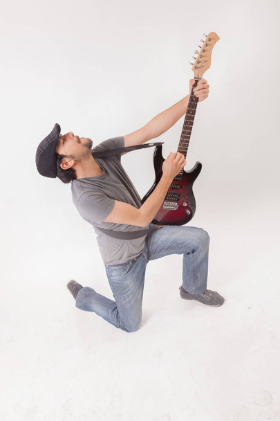 young man jumping with electric guitar - Valokuva, kuva
