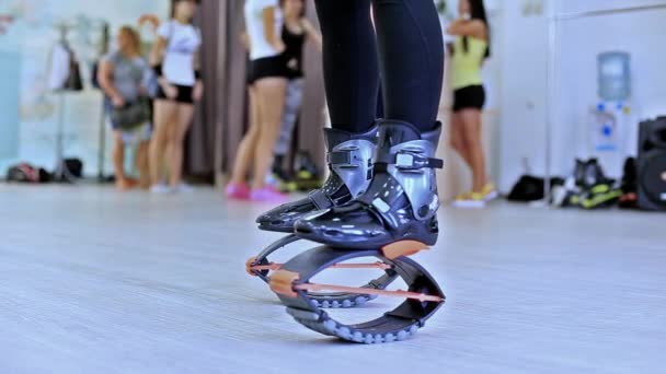 Csoport fiatal sportos kaukázusi nők csinál a kangoo fitness gyakorlatok ugrik, cipőt, egy tornaterem. - Felvétel, videó