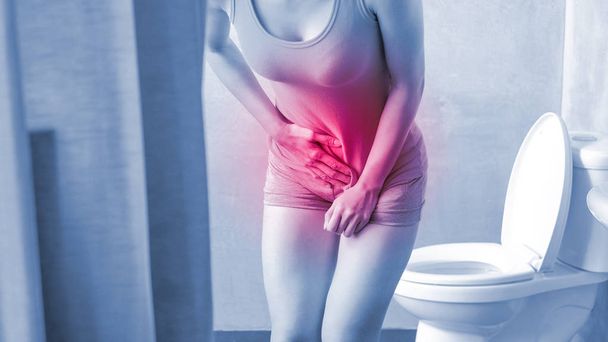 woman with urine urgency in the toilet - Zdjęcie, obraz