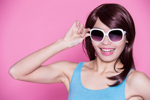 woman in  sunglasses posing on the pink background - 写真・画像
