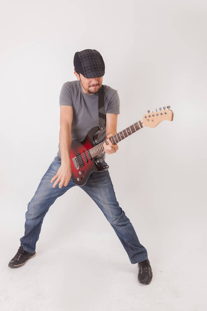young man jumping with electric guitar - Foto, imagen