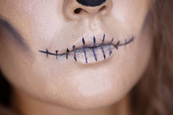 Halloween holidays. Close up portrait of female with skull make up. mouth close up - Fotografie, Obrázek