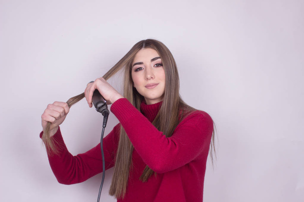 beautiful young teen girl using straightner - Foto, immagini