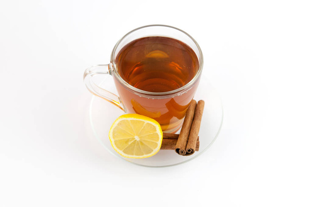Tea cup with lemon and cinnamon isolated on white background. - Fotó, kép