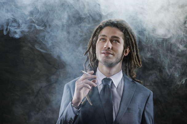 Businessman smoking a joint - Fotoğraf, Görsel