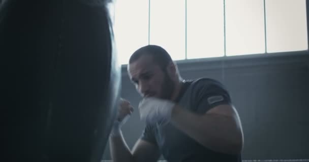 Boxer training with punchbag - Кадры, видео