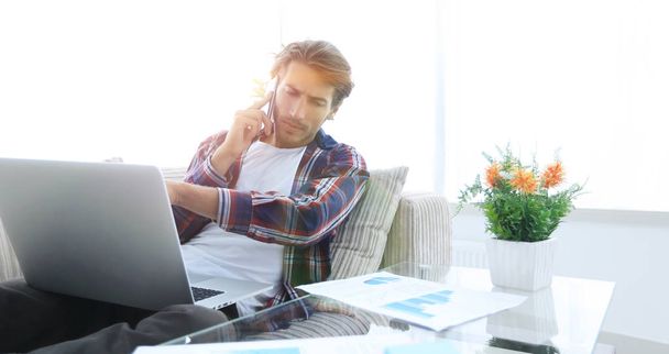 modern man working with financial documents in living room - Foto, imagen