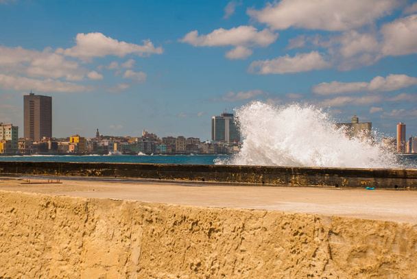 Splashes of waves .View from the Malecon promenade to the city. Cuba. Havana. - Photo, image