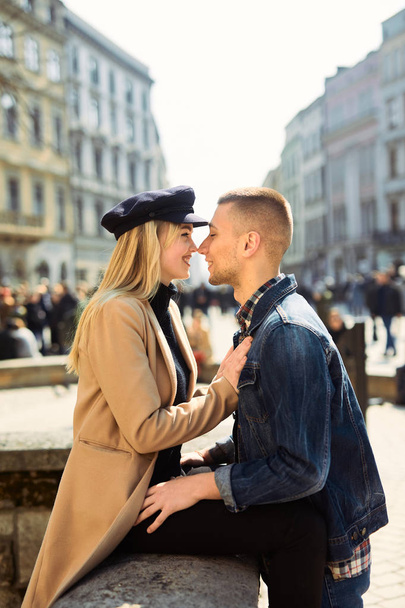 Lovely couple stand on city landscape and hug each other with su - Photo, image