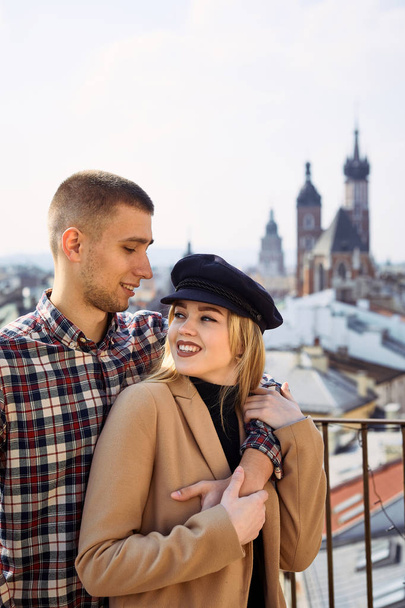 Lovely couple stand on city landscape and hug each other - Zdjęcie, obraz