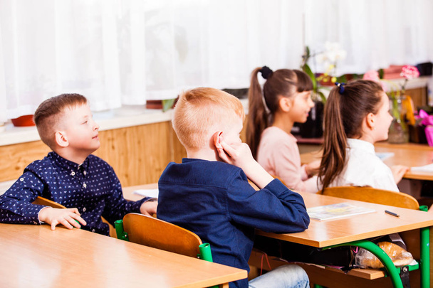 cute pupils are listening their teacher on the lesson - Fotografie, Obrázek
