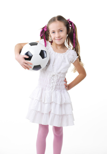 Pretty young girl holding a soccer ball - 写真・画像