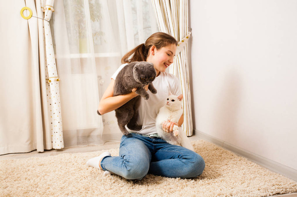 young girl is having fun with her cats - Fotoğraf, Görsel