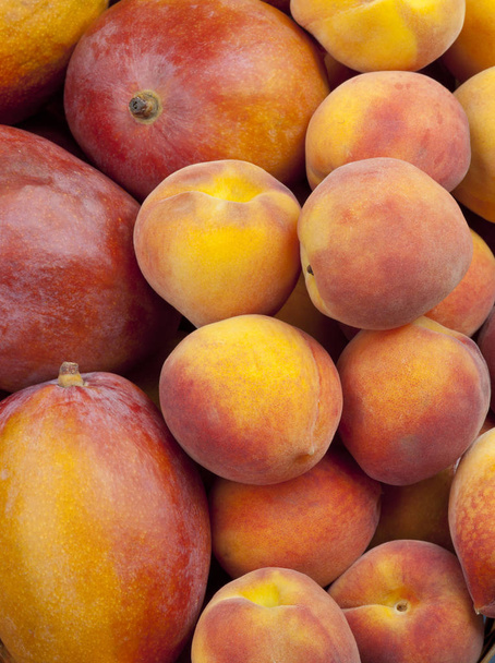 Group of Fresh Peaches and Mangos Background Top Shot - Photo, Image