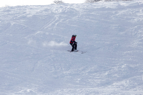 Sportler beim Skifahren in den verschneiten Bergen - Foto, Bild