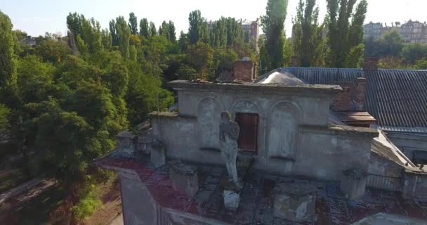 Aerial view: Old broken statue on roof of ruined building - Footage, Video