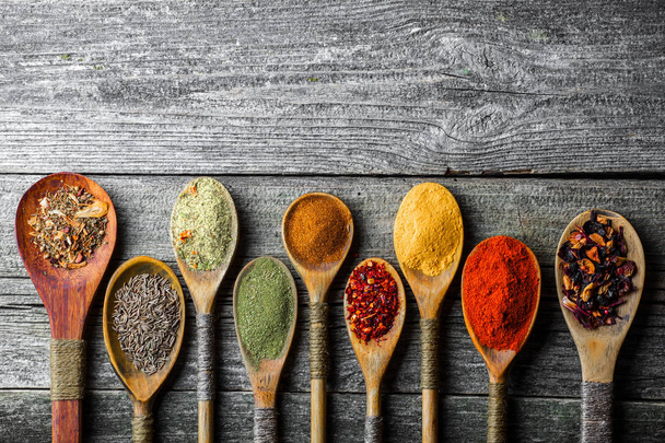 Spices for cooking with kitchen accessories on an old background - Foto, immagini