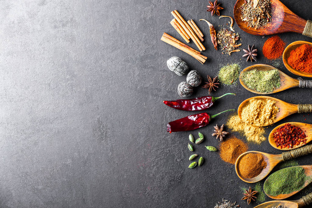 Spices for cooking with kitchen accessories on an old background - Foto, imagen
