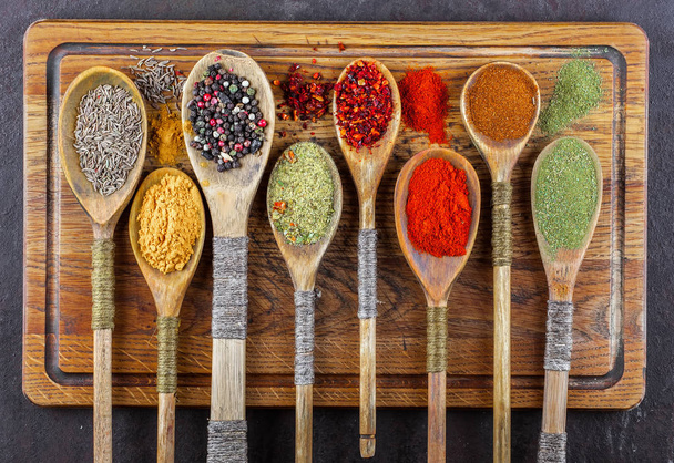 Spices for cooking with kitchen accessories on an old background - Photo, Image