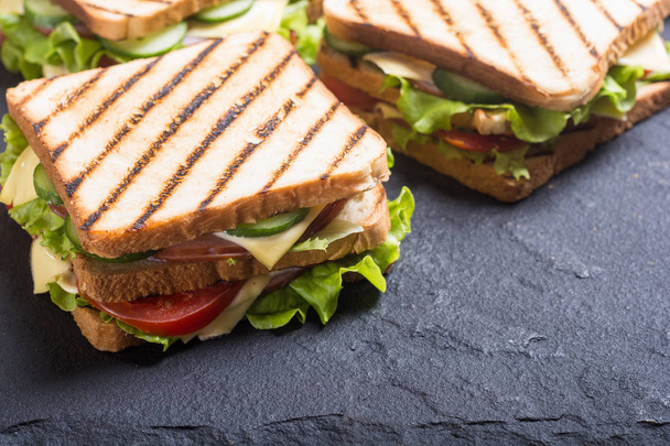 Club sandwich with tomatoes , cucumber , ham and cheese - Photo, Image